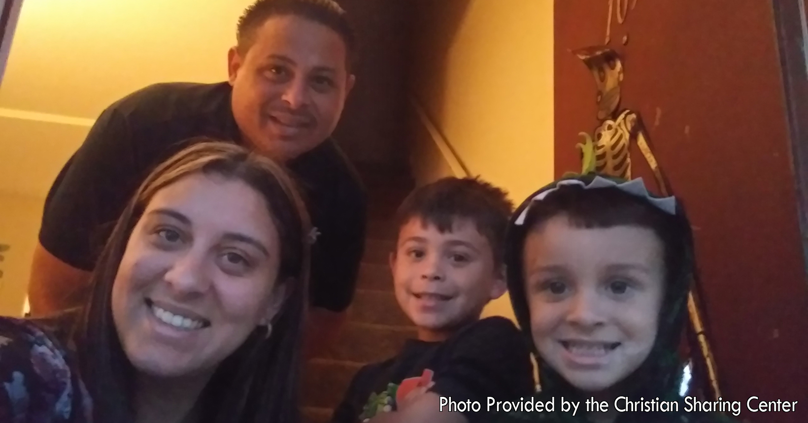 Captured by Teresa Engle a LifeBuilder Case Manager, a family gathers to take a photo during their time with the LifeBuilder program. This family of a mother and father with two young boys, started their journey with LifeBuilder in September of 2019.