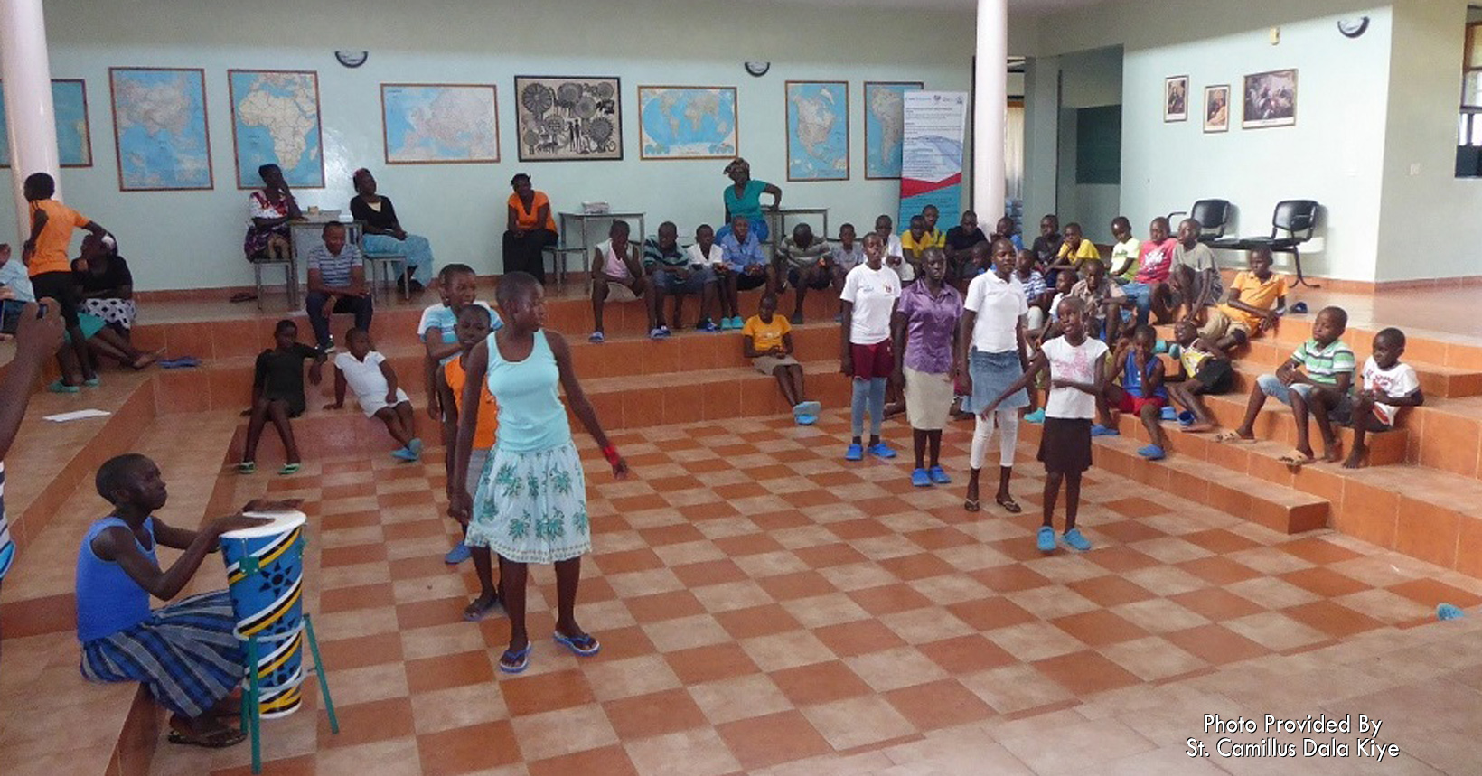 Children gather in the auditorium for dancing.