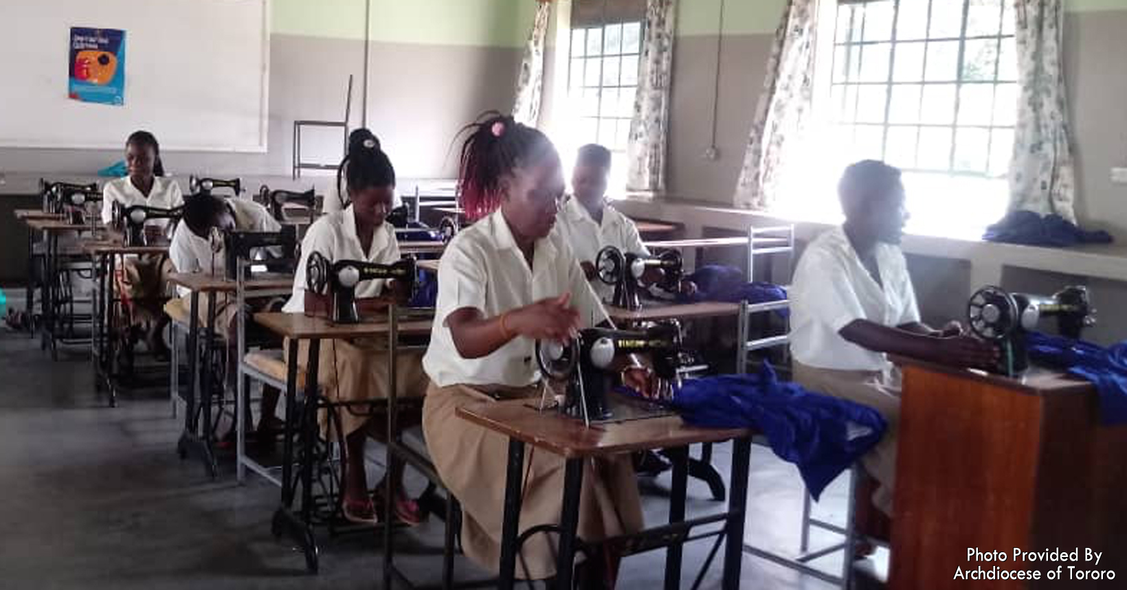 All the young girls are sitting down learning how to tailor. Tailoring is one of the skills the young girls are learning while they stay with the Vocational Training Institute.