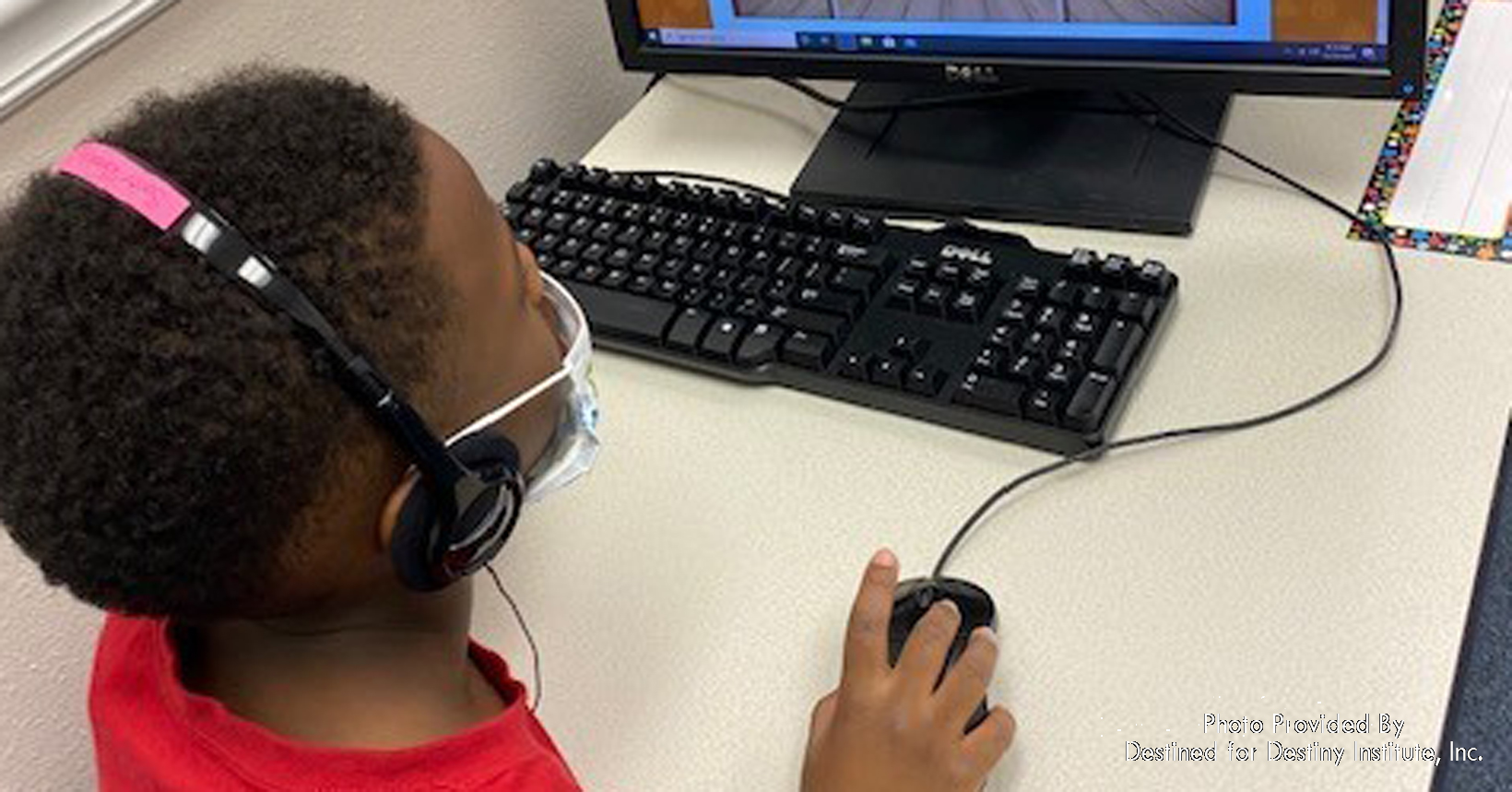 A young student, Savier, is having computer time at Destined for Destiny Institute. He is learning to increase his vocabulary.