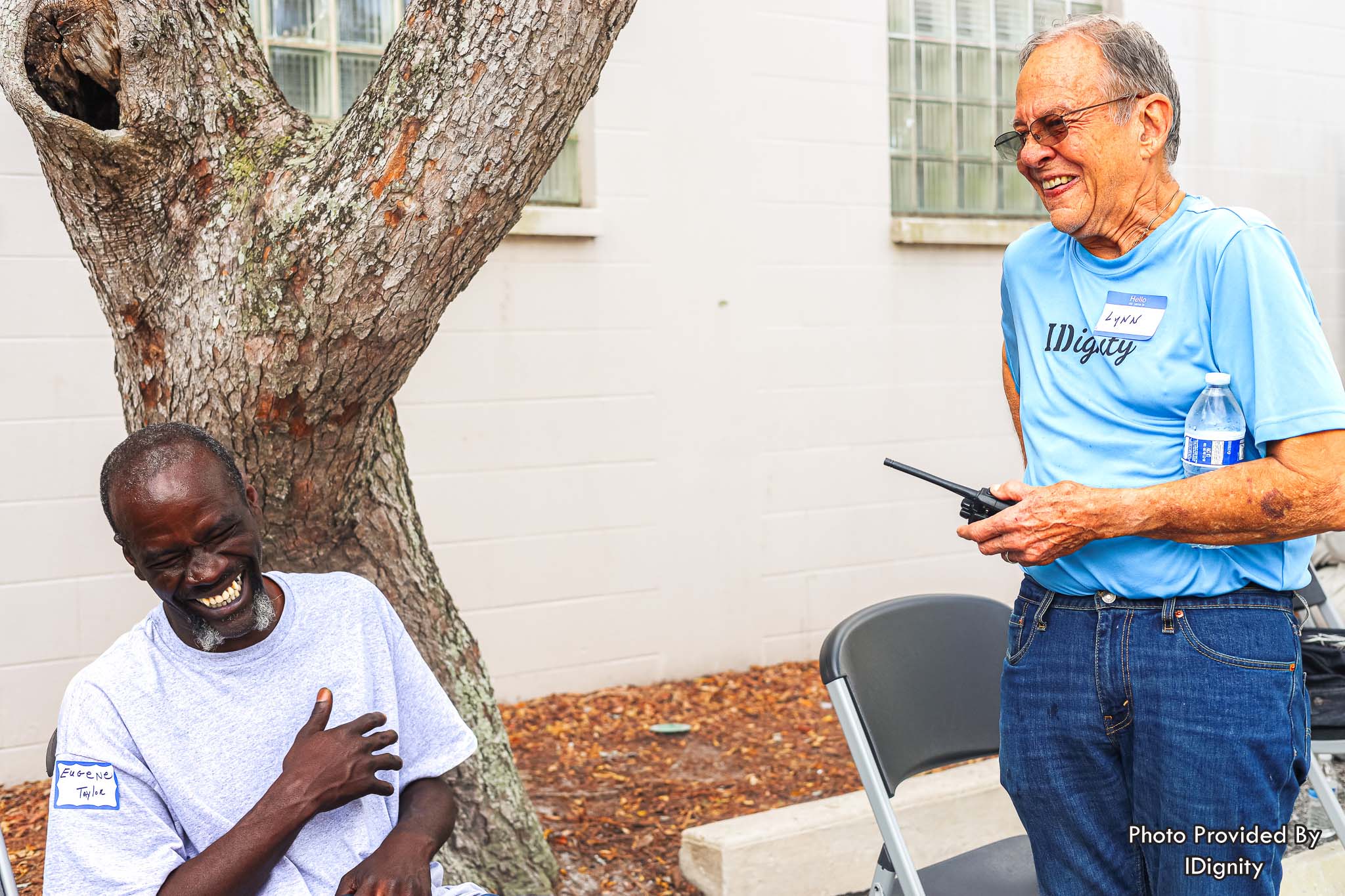 Volunteer Lynn shares a laugh with client Eugene. Helping our neighbors gain proof of their identity brings joy to both our volunteers and the clients that they serve. IDignity’s volunteers are essential to its mission to restore dignity and hope by providing identification.