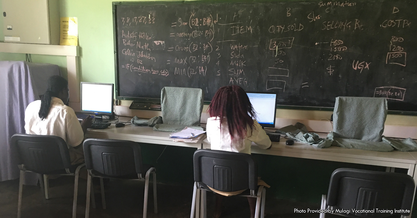 A computer classroom with two students