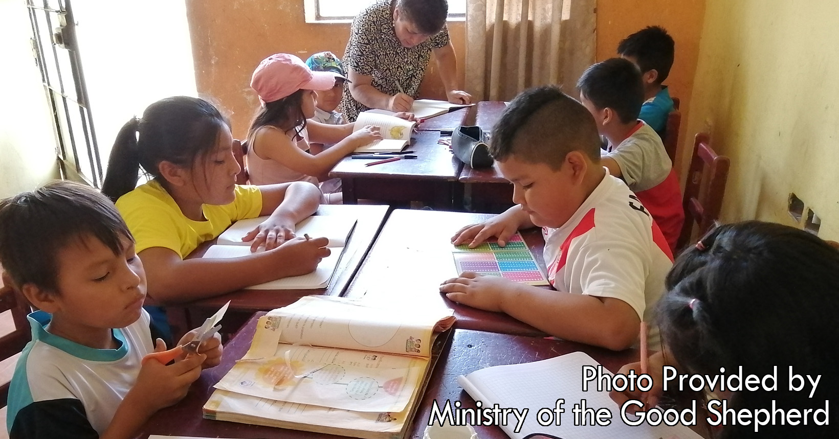 In this Child Care Center, the young kids are grouped into fours each having their own individual desk. The eight kids are reading & writing during the day to learn more and to grow into young adults.