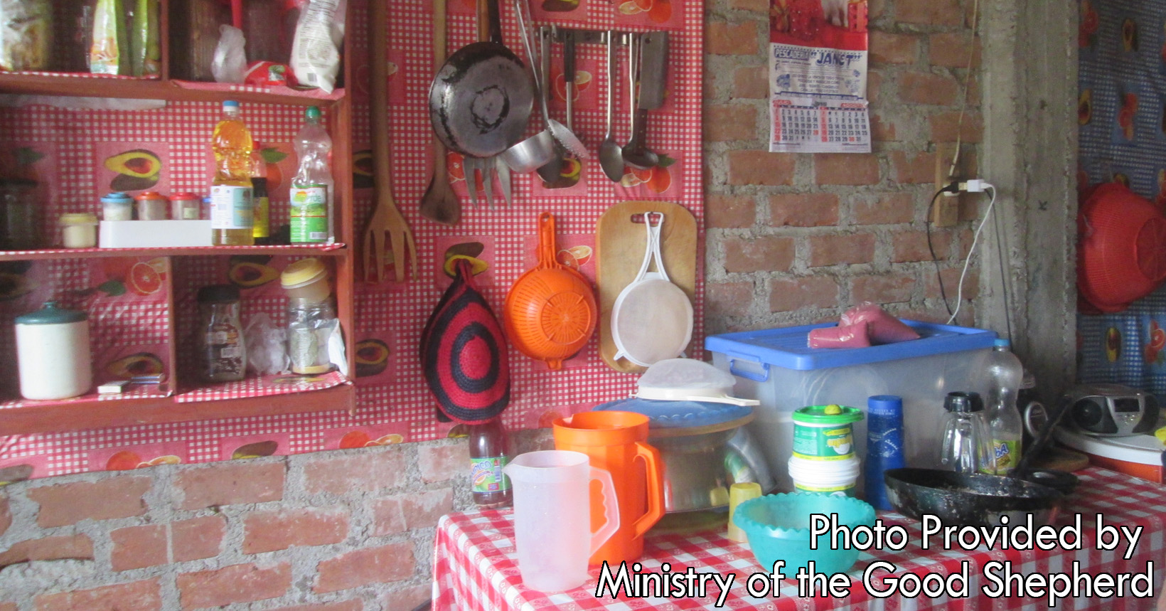 The Ministry of the Good Shepard keeps all their utensils for cooking and cleaning organized. All pans and pots are hanging in their correct spot and the shelves are neatly put together.