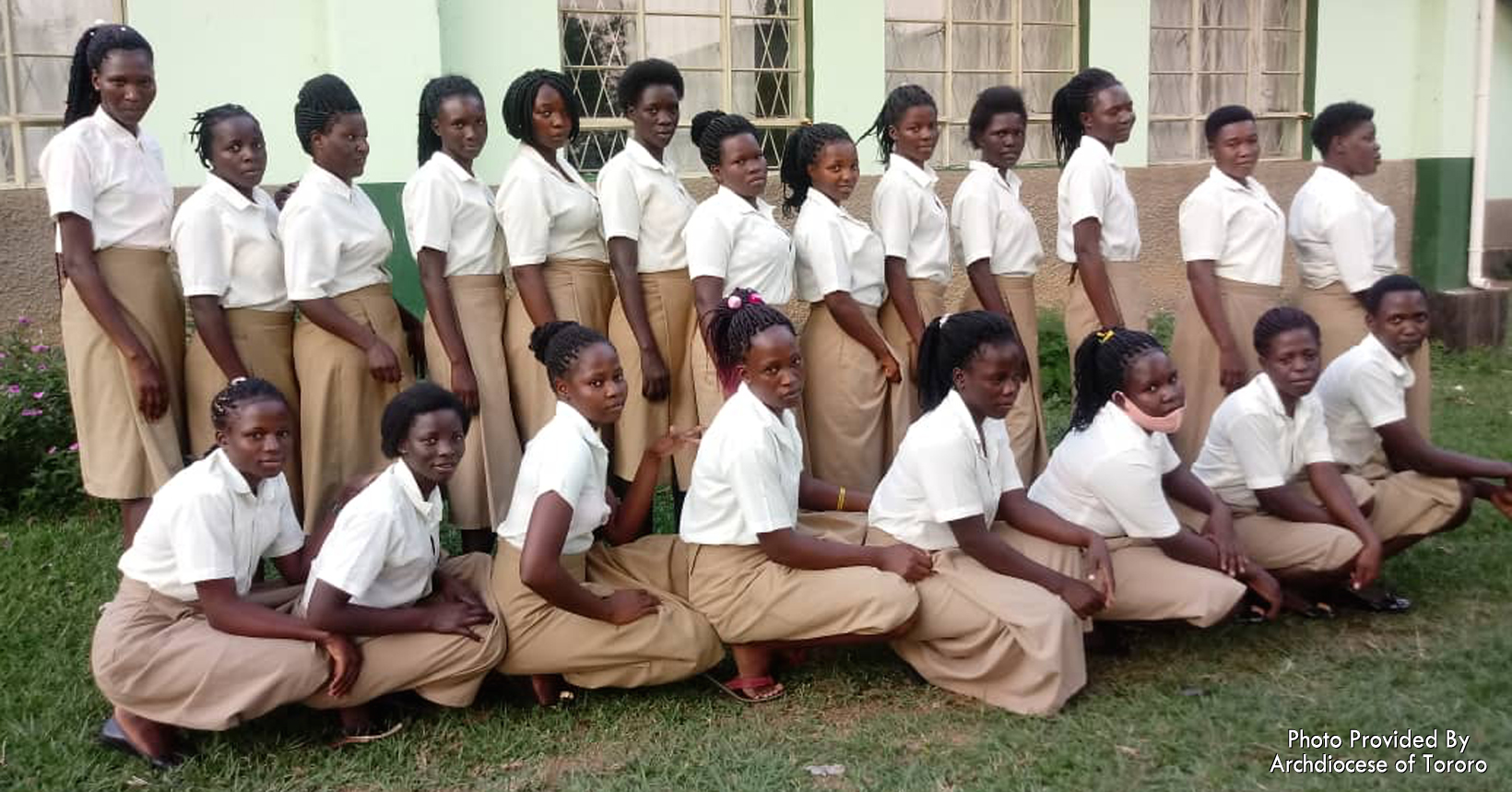 A group of young girls who are a part of the Vocational Training Institute come together for a picture.