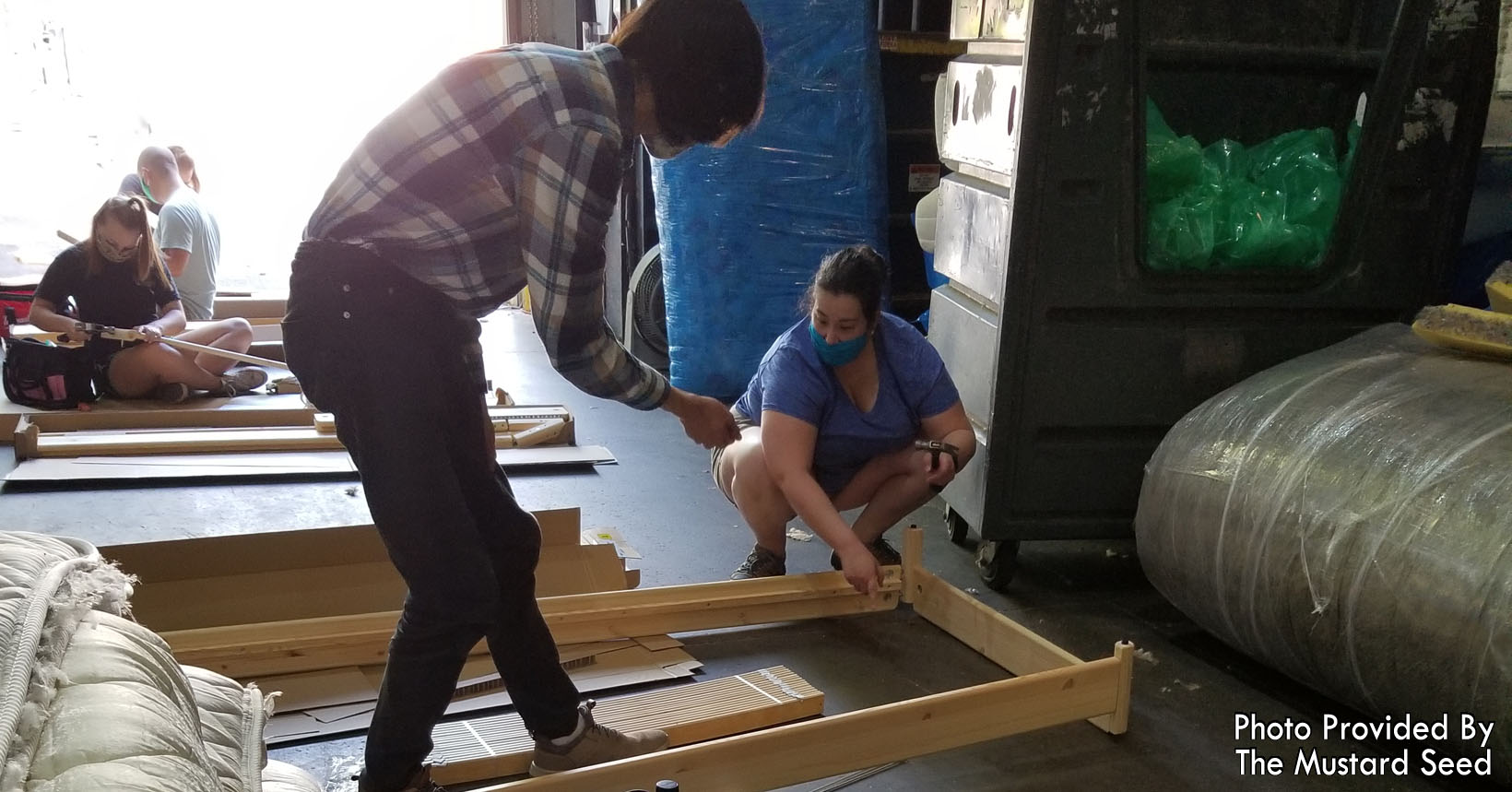 Volunteers from WGI are constructing the stackable beds.