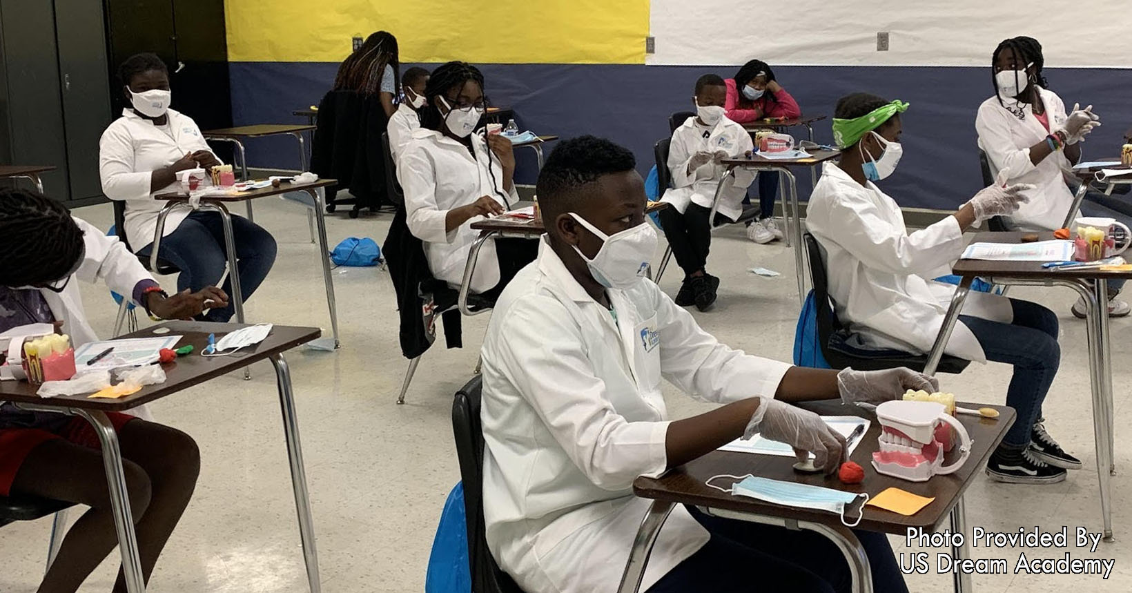 Kids learn what cavities look like and work on brushing techniques during a dental class from U.S. Dream Academy.