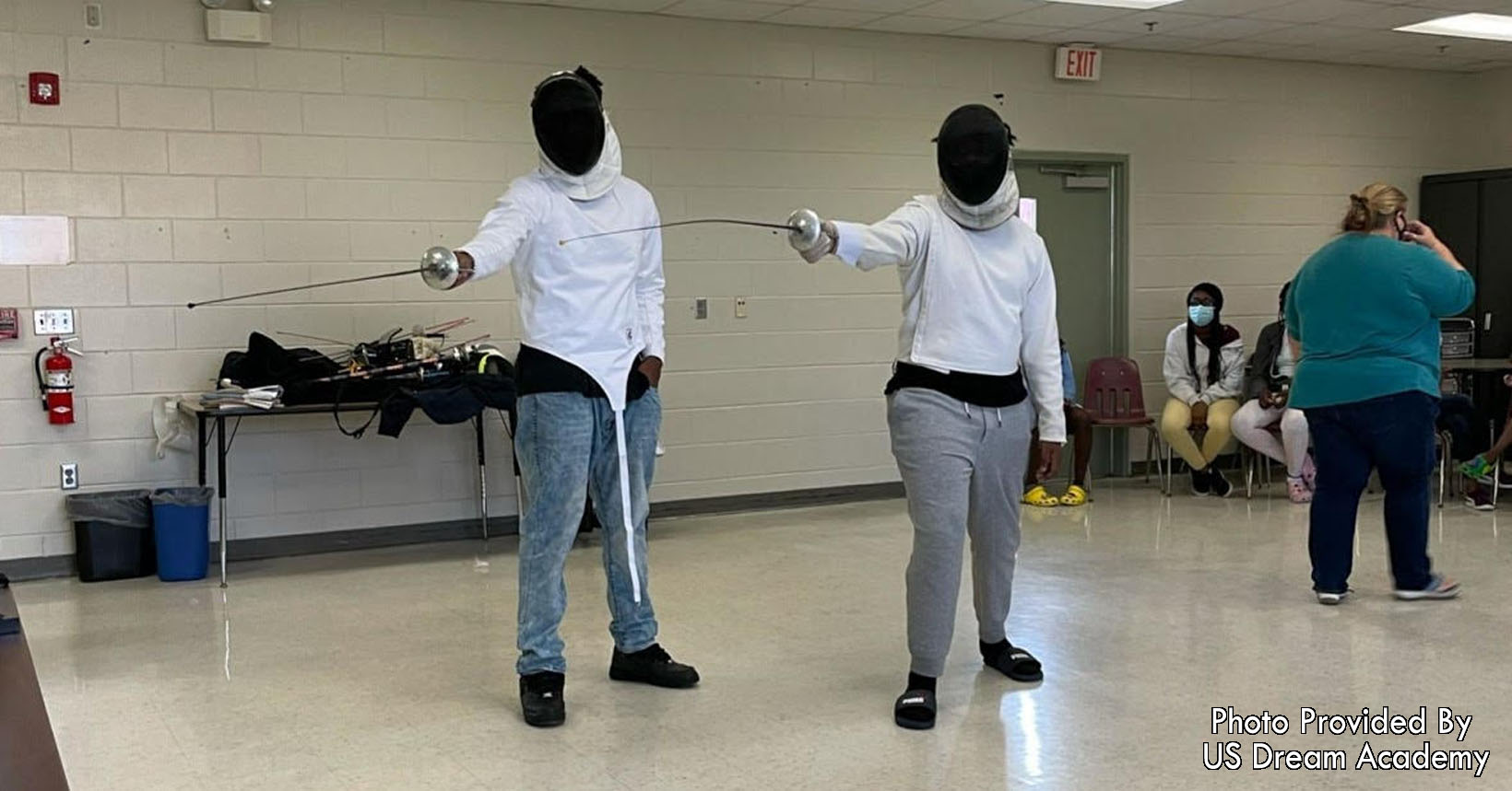 Two students learning fencing.